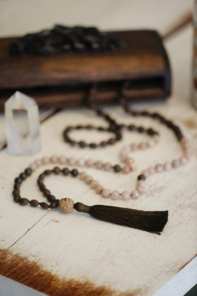 a mala beads necklace with brown tassel